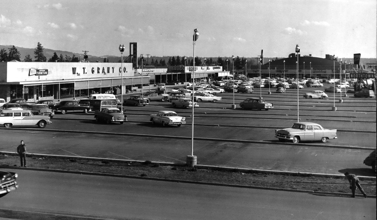 1960: The modest NorthTown shopping center, built in 1951, is shown in 1960 photo before a new Sears store and a branch of The Crescent department store opened in 1962 and greatly expanding the center. It was The Crescent’s first store outside of downtown and occupied 60,000 square feet of floor space. The 1950s shopping center was redeveloped as an indoor two-story indoor shopping mall in the 1990s, making it the largest in Eastern Washington. (The Spokesman-Review photo archive / SR)