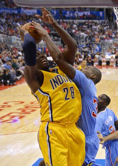 Indiana Pacers center Ian Mahinmi, left, goes to the rim but has his shot blocked by Los Angeles Clippers forward Antawn Jamison. (Associated Press)