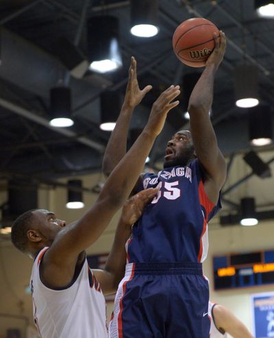 Gonzaga’s Sam Dower, right, puts up a shot over Pepperdine’s Stacy Davis in second half. (Associated Press)