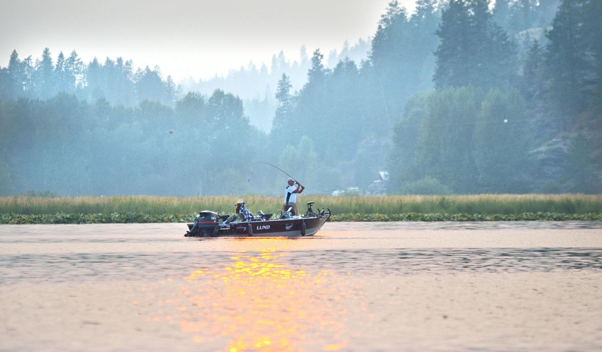 “The last few summers have been like this,“ said Jim Eggart of Walla Walla as he fished through the smokey air at Hauser Lake with his wife Julie on Thursday, August 16, 2018. The Eggart’s have a summer home on Hauser. (Kathy Plonka / The Spokesman-Review)