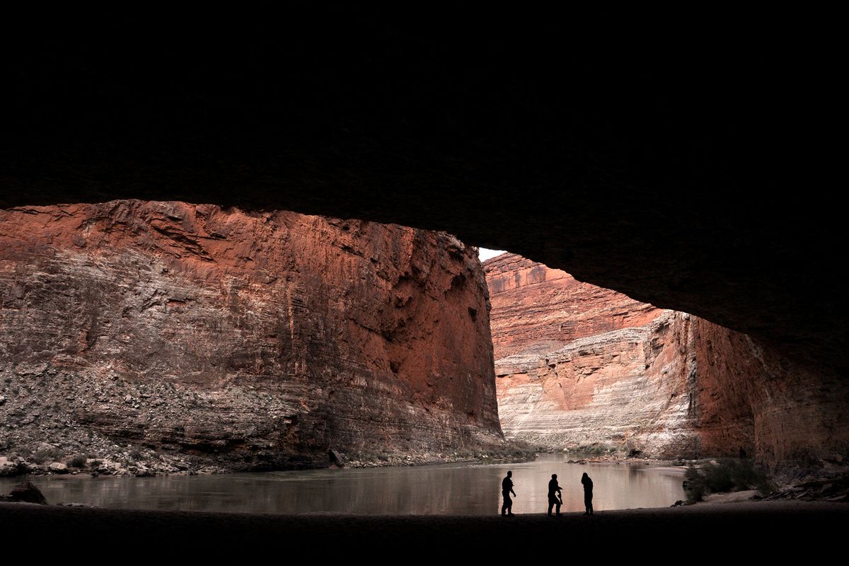 Rafters explore Redwall Cavern at River Mile 33 on the Colorado River during a winter float through Grand Canyon National Park.