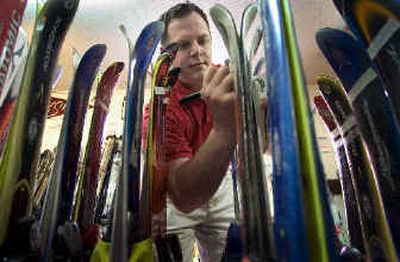 
Loulou's Ski Chalet manager Doug Gulbran marks down prices Wednesday at the shop, which is closing after over 30 years.
 (Colin Mulvany / The Spokesman-Review)