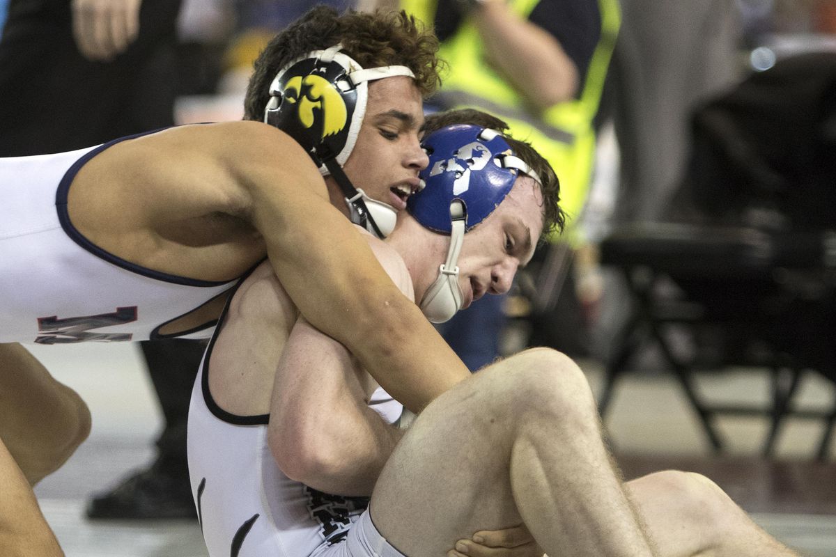 Mount Spokane’s Blake Haney, left, works to control Bonney Lake’s Evan Tracy during their 126-pound championship match at the State 3A meet in Tacoma on Saturday. Haney won 7-2 to take the title. (Patrick Hagerty / For The S-R)