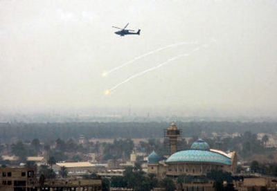 
A U.S. military helicopter releases anti-missile decoy flares while flying over central Baghdad where about 1,000 Iraqi and U.S. troops battled gunmen  early Tuesday.
 (Associated Press / The Spokesman-Review)