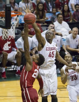 WSU’s Valentine Izundu , blocking Oklahoma’s Buddy Hield, wants to transfer to San Diego State. (Eugene Tanner / Associated Press)