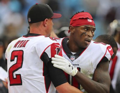 Falcons wide receiver Julio Jones gives quarterback Matt Ryan a hug on the sidelines after he dropped a certain touchdown pass in the end zone during the fourth quarter against the Panthers in a NFL football game on Sunday, Nov. 5, 2017, in Charlotte. The Panthers held on to beat the Falcons 20-17. (Curtis Compton / Atlanta Journal-Constitution via AP)