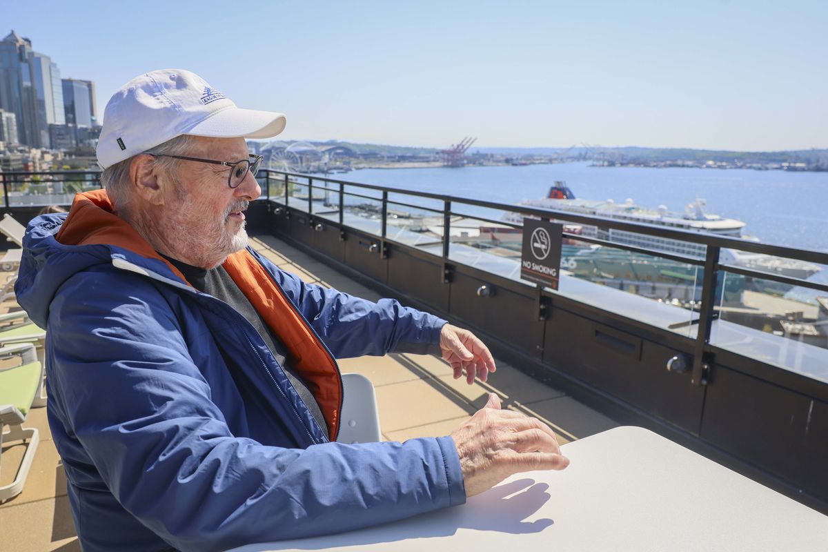 Alex Smith, 80, looks over Elliott Bay from his apartment building’s Seattle rooftop on Thursday. (Ivy Ceballo/The Seattle Times/TNS)