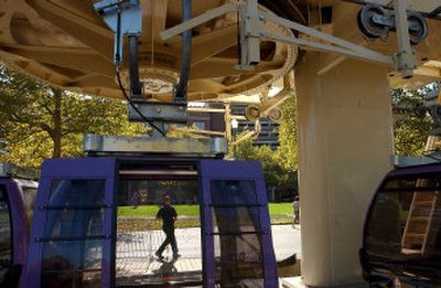 
Workers install temporary fencing around the SkyRide Friday in preparation for its reopening today at Riverfront Park. Additional permanent improvements for the ride will be completed in the next few weeks. 
 (Brian Plonka / The Spokesman-Review)