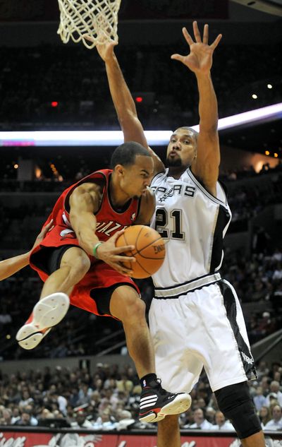 Portland Trail Blazers guard Jerryd Bayless looks to pass as San Antonio Spurs forward Tim Duncan closes in on Wednesday.  (Associated Press)