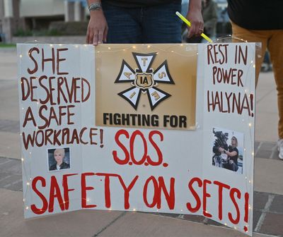 Wynema Chavez Quintana holds a sign calling for better safety on movie sets during a vigil held to honor cinematographer Halyna Hutchins at Albuquerque Civic Plaza on Oct. 23, 2021, in Albuquerque, N.M. New Mexico prosecutors are expected to bring criminal charges as early as this week.   (Sam Wasson/Getty Images North America/TNS)