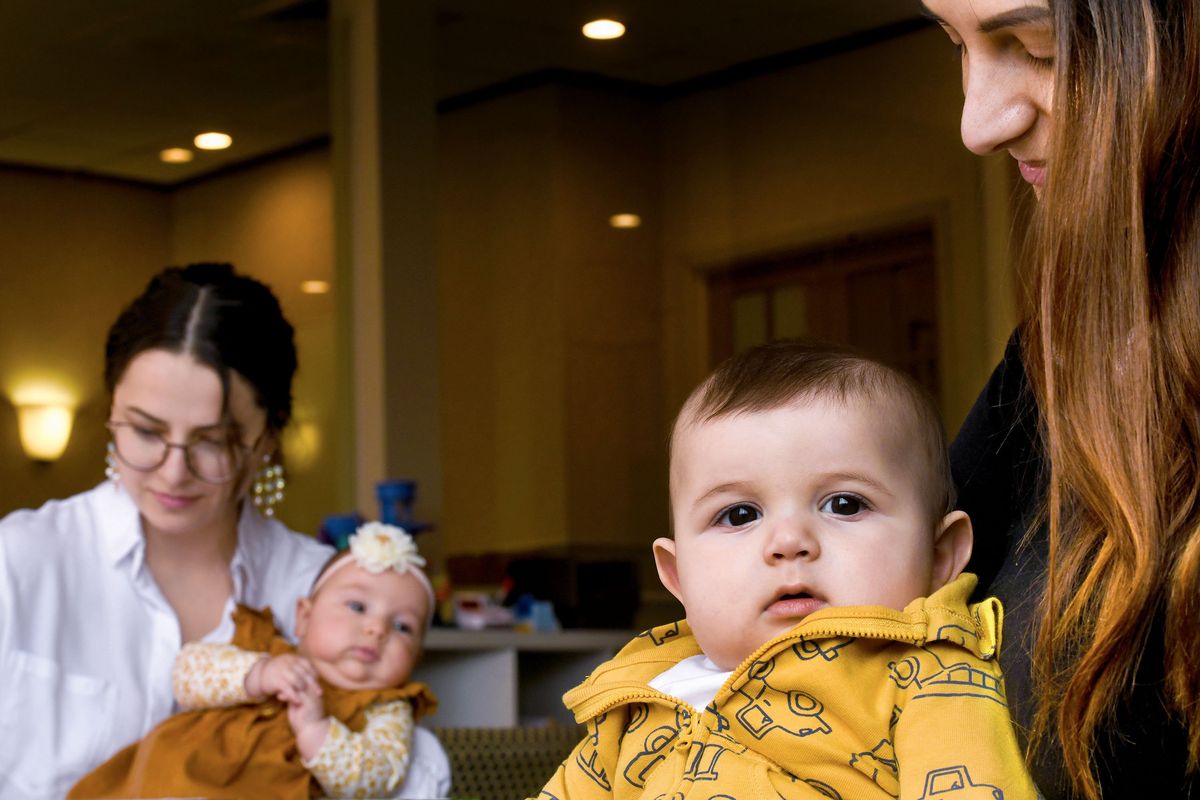 Dominic Sashchin, 6 months, is held by his mother Tetiana with his cousin Nicole Kharkivska, 3 months, and aunt Olena Nikora on Feb. 10 at the Thrive Center in Spokane.  (KATHY PLONKA/THE SPOKESMAN-REVIE)