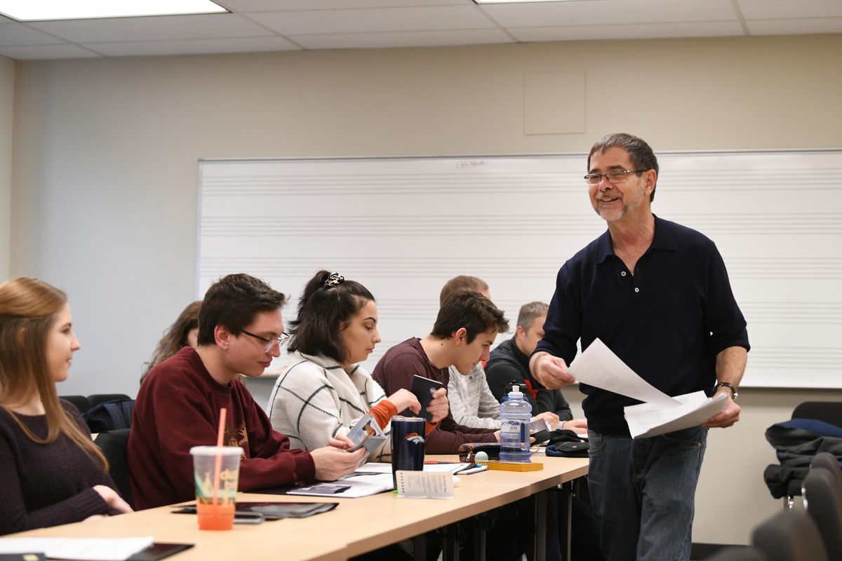 Whitworth professor Dale Soden passes out last-minute reading material and visa applications Friday, Jan. 4, 2019, to his class traveling to Vietnam.  The students will be looking at the geopolitical and long-lasting impacts of the Vietnam War. (Jesse Tinsley / The Spokesman-Review)