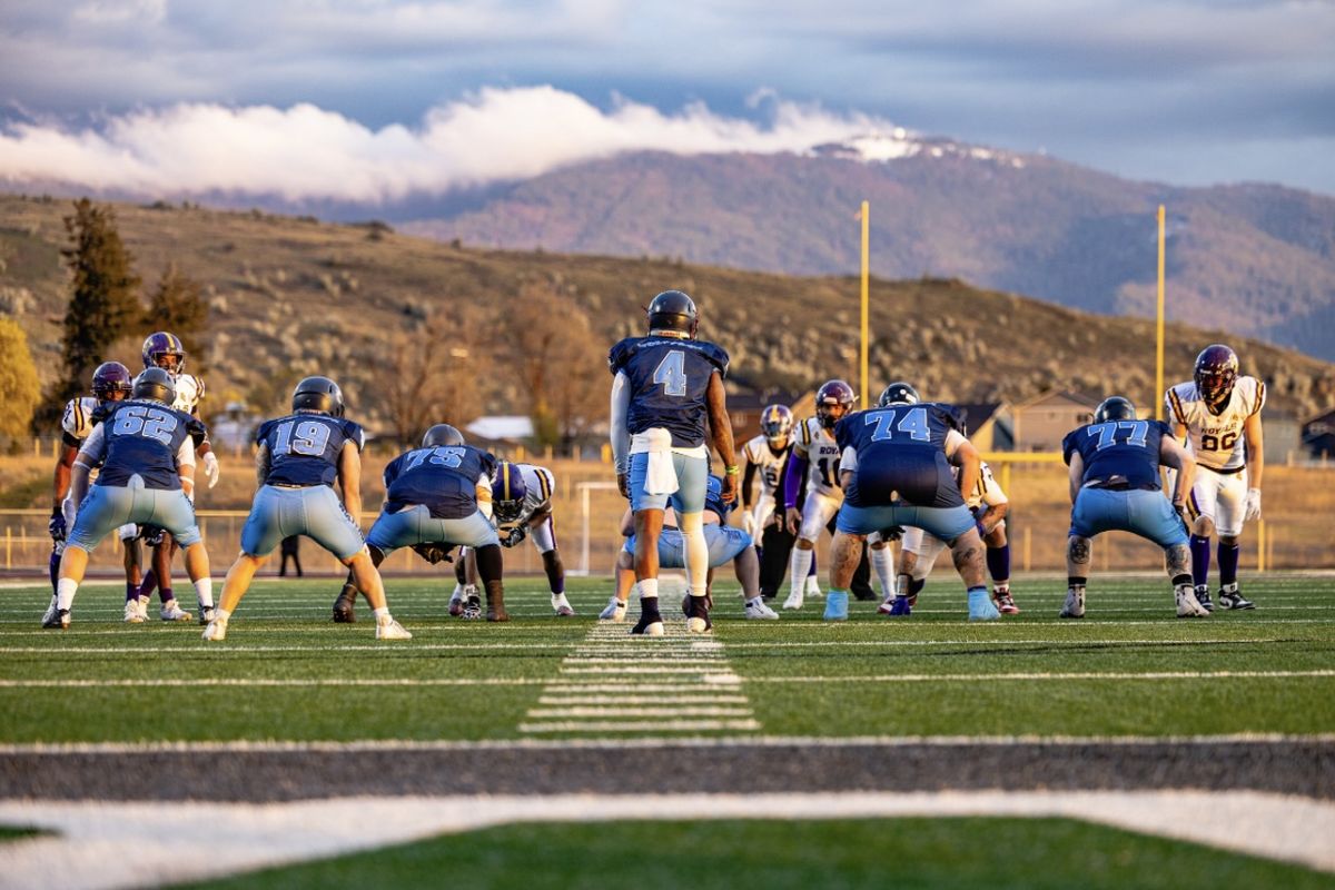 Wolfpack quarterback, Harry Peoples, and his offense line up in preparation for the snap.  (Courtesy of Demetrius Palmer)