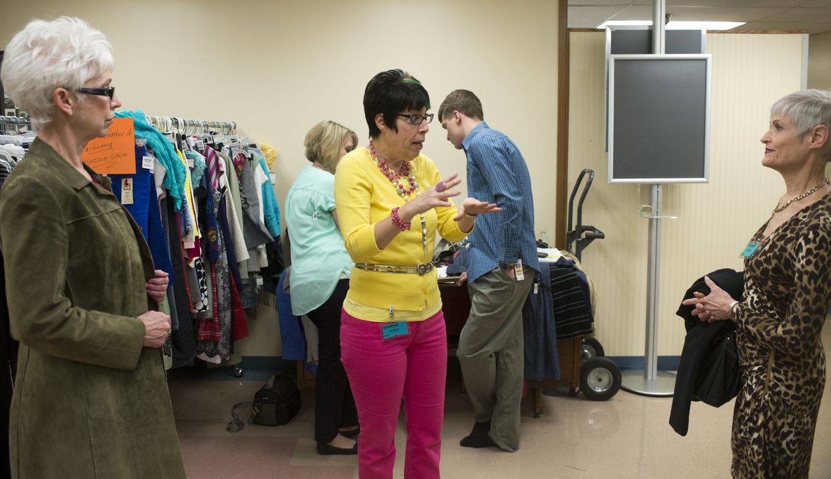 Style consultant Cheryl Smith, center, talks to volunteer models Kathy McClure, left, and Trudy Raymond, right, at Goodwill on East Third Avenue in Spokane on April 10. (Jesse Tinsley)