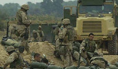 
U.S. Marines take position on the northern outskirts of Fallujah on Monday. 
 (Getty Images / The Spokesman-Review)