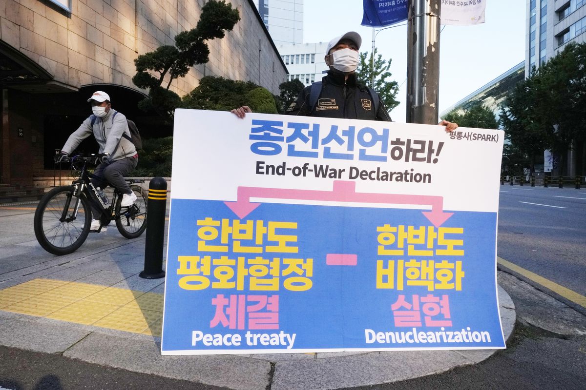 A man, holding a banner, stands to denounce policies of the United States and South Korean government on North Korea in Seoul, South Korea, Sunday, Oct. 24, 2021. A senior U.S. diplomat on Sunday urged North Korea to end a recent series of missile tests and resume negotiations, days after the North performed its first underwater-launched ballistic missile launch in two years. (Ahn Young-joon)