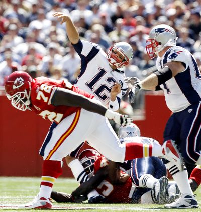 Patriots quarterback Tom Brady injured his knee on this hit by the Chiefs’ Bernard Pollard (on ground) Sunday. (Associated Press / The Spokesman-Review)