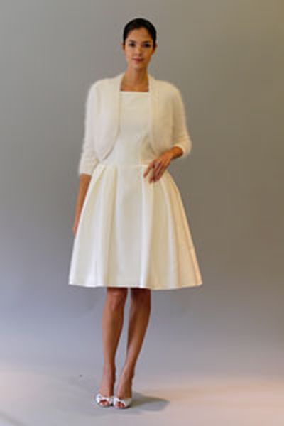 Silk mikado cocktail dress with full party skirt, pockets and top stitch bodice details and angora knit bolero from Carolina Herrera