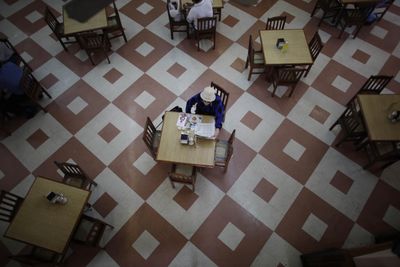 A woman has breakfast in Mexico City on Wednesday  after a shutdown to contain swine flu ended. (Associated Press / The Spokesman-Review)