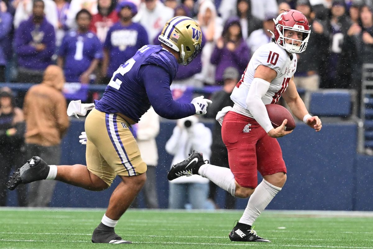 Washington State quarterback John Mateer scrambles against Washington’s defense during the second half of Saturday’s Apple Cup at Lumen Field in Seattle.  (Tyler Tjomsland/The Spokesman-Review)