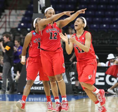 The Lady Bulldogs, including Jasmine Hassell, celebrates after defeating top-seeded Stanford at the Arena Saturday night. (Tyler Tjomsland)