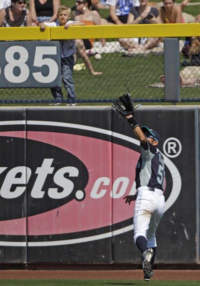 Mariners’ Ichiro Suzuki makes a running catch to take a hit away from Kansas City Royals' Melky Cabrera. (Associated Press)
