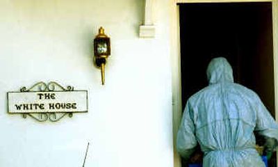 
A suited British police forensic expert enters a house called, The White House, in Bushey, England, Wednesday, where one person was arrested under Britain's anti-terrorist laws late Tuesday in a nationwide anti-terrorist operation. 
 (Associated Press / The Spokesman-Review)