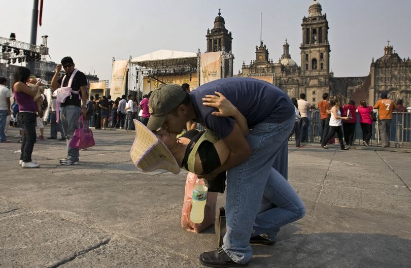 ORG XMIT: MXCC103 A couple kisses in Mexico City, Saturday, Feb. 14, 2009. Thousands gathered in Mexico City's central plaza to pucker up for peace and break the world record for the largest number of people kissing at one time. (AP Photo/Claudio Cruz) (Claudio Cruz / The Spokesman-Review)