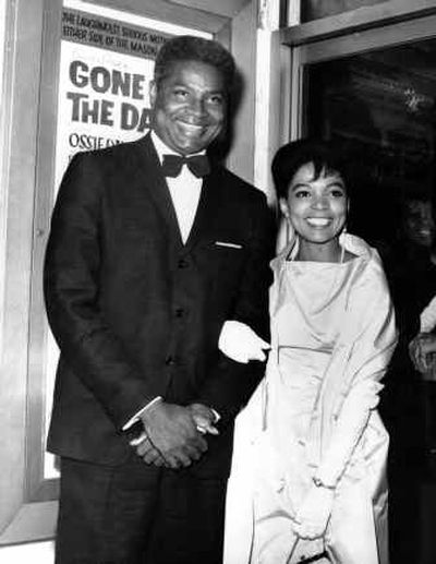 
 Ossie Davis and wife, Ruby Dee, pose in front of their movie poster at the opening night gala of their film 