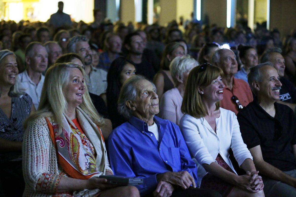 Legendary mountain climber Fred Beckey, second from lower left, sits next to Megan Bond, left, his friend and companion, as they view a trailer for “Dirtbag: The Legend of Fred Beckey,” an upcoming documentary feature film about his life, at a sold-out fund-raising event in Seattle. Beckey, 93, has bagged more first ascents than any other mountaineer and wrote the definitive guidebooks to a major North American mountain range. (Ted S. Warren / Associated Press)