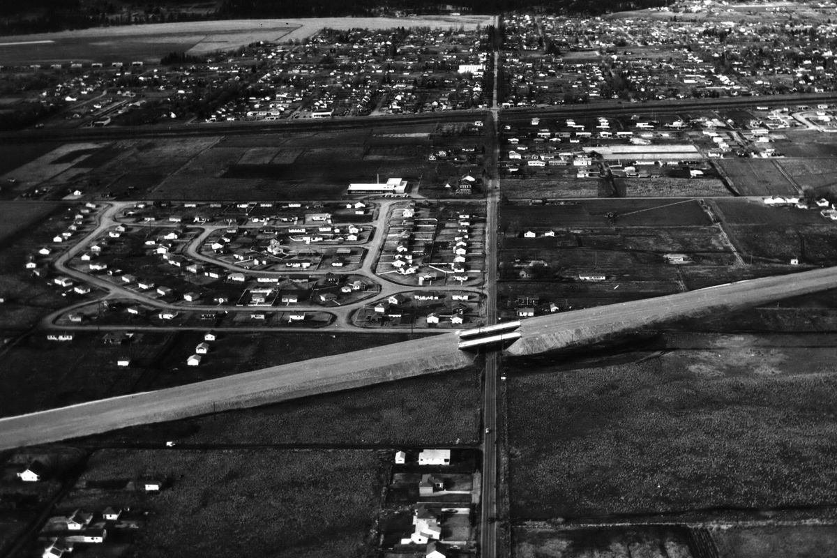 1955: This aerial photo, looking north along Park Road near Broadway Avenue, shows the Spokane Valley Freeway as it crosses Park Road with a double-lane overpass. The new Seth Woodard School can be seen in the upper left area on Mission Avenue.  (Spokesman Review Photo Archives)