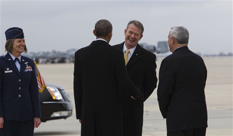 President Barack Obama, second from left, greets Idaho Lt. Gov. Brad Little, center, after arriving on Air Force One, Wednesday, Jan. 21, 2015, at Gowen Field Air National Guard Base in Boise, Idaho, en route to Boise State University for a speech. (AP/Idaho Statesman / Darin Oswald)