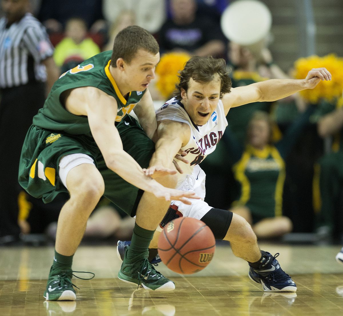 Gonzaga guard Kevin Pangos, right, and North Dakota State guard Paul Miller chase a loose ball in the second half. (Colin Mulvany)