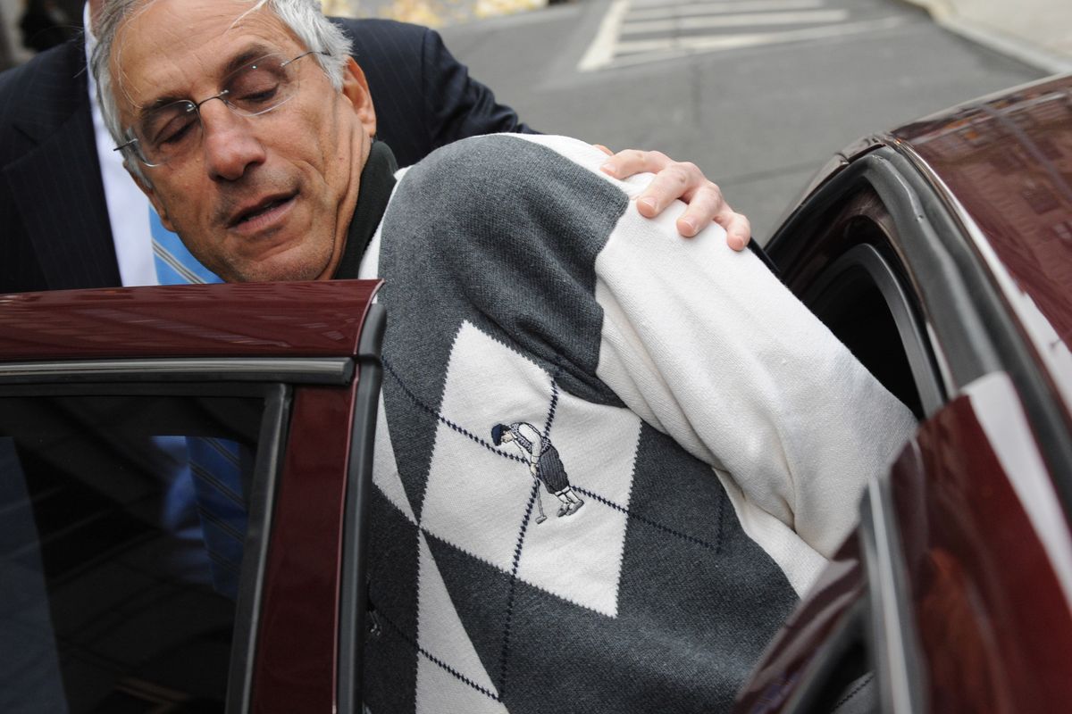 Mark Kurland is led in handcuffs from FBI headquarters in New York Friday. (The Spokesman-Review)