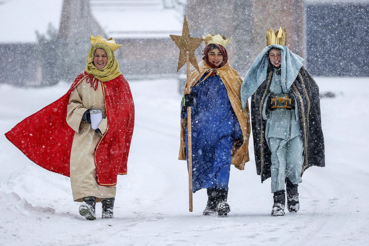Coral singer in traditional costumes walk through the snow in Eglingen, southern Germany, on Saturday, Jan. 5, 2019. (Thomas Warnack / AP)