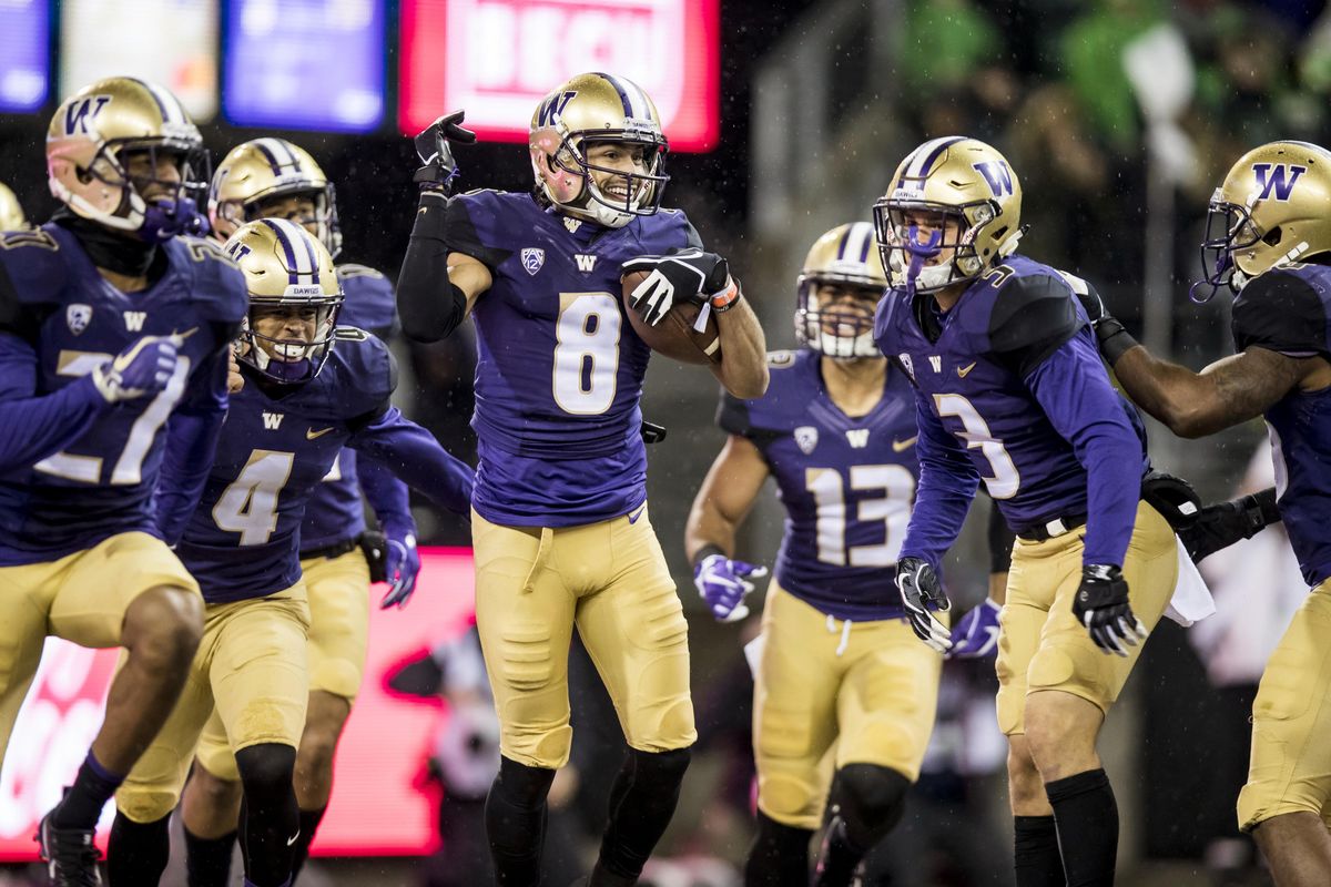Washington’s Dante Pettis celebrates with teammates after his 64-yard punt-return touchdown against Oregon in the first half of an NCAA college football game in Seattle on Saturday, Nov. 4, 2017. Pettis holds the NCAA record for punt returns for touchdowns with nine. (Bettina Hansen / Associated Press)