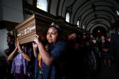 
Nobel laureate and presidential candidate Rigoberta Menchu carries the coffin of Esmeralda Uyun Sican in San Raymundo, Guatemala, on Friday. Uyun, a candidate for a San Raymundo city council seat, was killed by assailants. Associated Press
 (Associated Press / The Spokesman-Review)