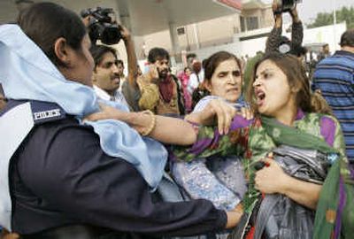 
Supporters of opposition leader Benazir Bhutto scuffle with police Tuesday  in front of a house in Lahore, Pakistan, where she is staying. Pakistani authorities mounted a massive security operation Tuesday to hold Bhutto under house arrest.Associated Press
 (Associated Press / The Spokesman-Review)