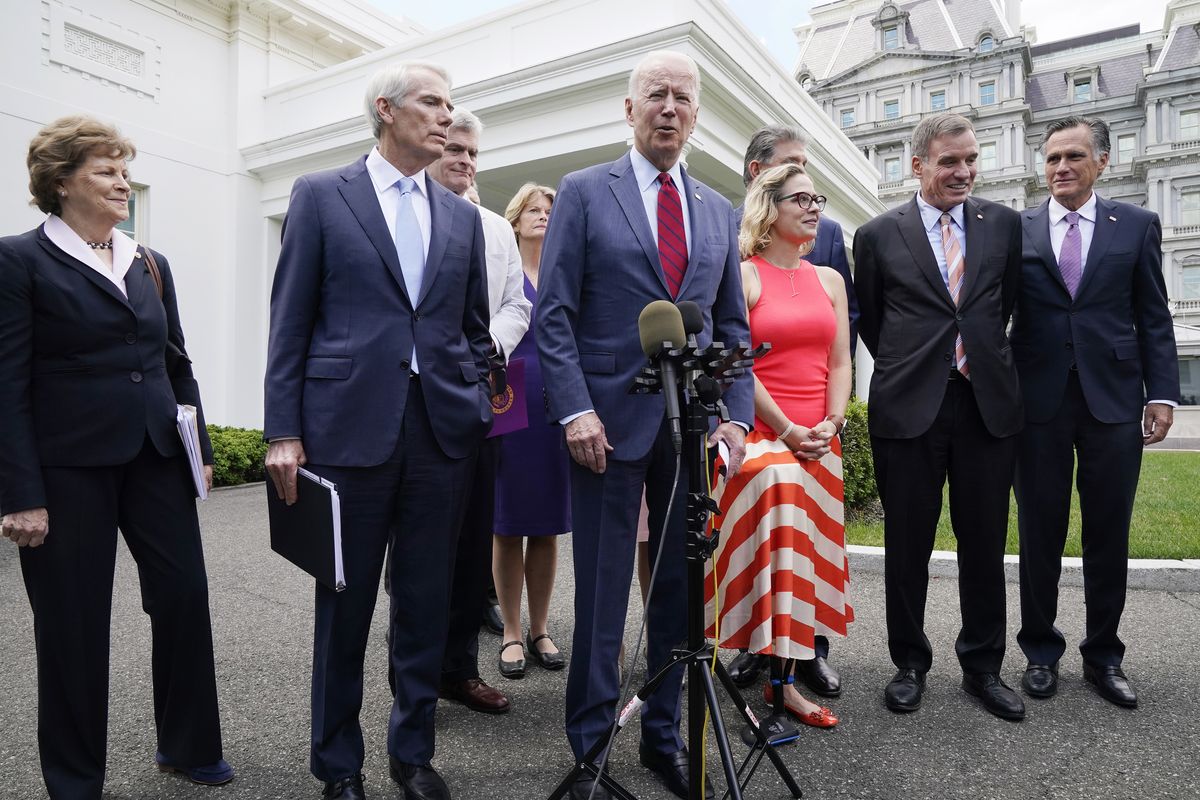 President Joe Biden, with a bipartisan group of senators, speaks Thursday June 24, 2021, outside the White House in Washington. Biden invited members of the group of 21 Republican and Democratic senators to discuss the infrastructure plan. From left are, Sen. Jeanne Shaheen, D-N.H., Sen. Rob Portman, R-Ohio, Sen. Bill Cassidy, R-La., Sen. Lisa Murkowski, R-Alaska, Biden, Sen, Joe Manchin, D-W.Va., rear, Sen. Kyrsten Sinema, D-Ariz, Sen. Mark Warner, D-Va., and Sen. Mitt Romney, R-Utah.  (Jacquelyn Martin)