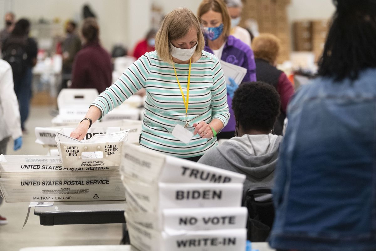 An election worker sorts through ballots during a Cobb County hand recount of Presidential votes on Sunday, Nov. 15, 2020, in Marietta, Ga.  (John Amis)