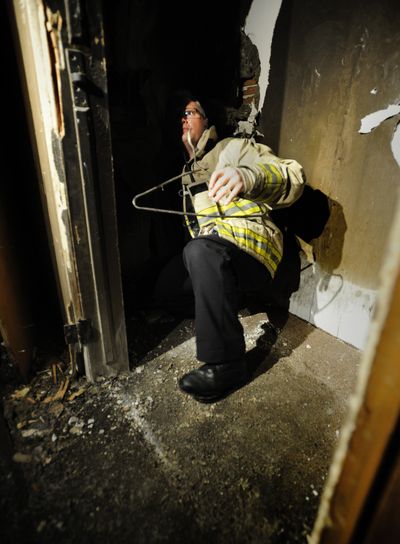 Spokane Assistant Fire Chief Brian Schaeffer demonstrates where the body of a 50-year-old man was discovered in the closet of a flame-damaged apartment building at 1203 W. Eighth Ave. on Thursday night. (Colin Mulvany)