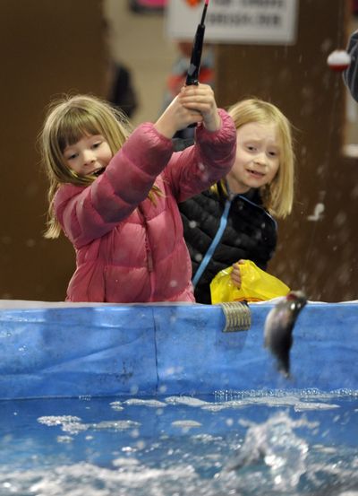 Catchy exhibit: Five-year-old Samantha Wilde, left, squeals with joy as her fish breaks the surface of a manmade pond at the 2013 Big Horn Outdoor Adventure Show on Thursday at the Spokane County Fair and Expo Center. At right is her sister, Clara Wilde, 8. The show, which runs through Sunday, features vendors of outdoor gear, hunting and fishing outfitters, displays of mounted trophies, seminars and demonstrations. The event, in its 51st year, is put on by the Inland Northwest Wildlife Council. More information can be found at www.wildlifecouncil.com/bighornsubsite/index.html. (Jesse Tinsley)
