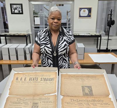Kathe Hambrick, executive director of Amistad Research Center, shows newspapers from the Louisiana Weekly Collection. It's one of the oldest Black newspapers still in circulation.   (Courtesy of  Amistad Research Center)