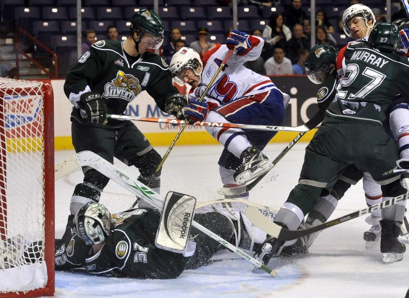 Chiefs Steven Kuhn and Brady Brassart (right) battle Everett defenders Rasmus Rissanen (8) and Ryan Murray (27) along with goalie Kent Simpson. (Dan Pelle / The Spokesman-Review)