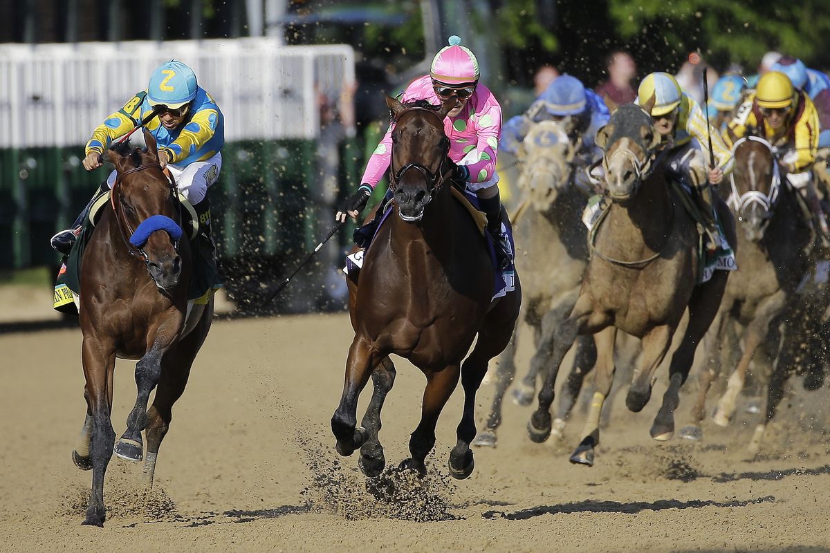 Victor Espinoza, left, jockeys American Pharoah past Firing Line, second from left, and on to victory in the 141st running of the Kentucky Derby horse race at Churchill Downs on Saturday. Espinoza won his second consecutive Derby. (Associated Press)