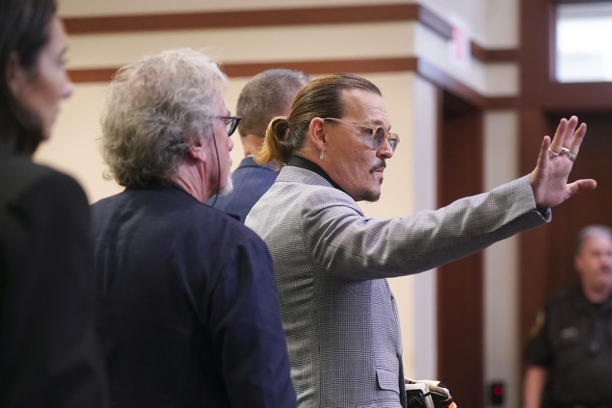 Actor Johnny Depp waves as he leaves the courtroom at the Fairfax County Circuit Courthouse in Fairfax, Va., Thursday, May 19, 2022. Actor Johnny Depp sued his ex-wife Amber Heard for libel in Fairfax County Circuit Court after she wrote an op-ed piece in The Washington Post in 2018 referring to herself as a "public figure representing domestic abuse." (Shaw Thew)