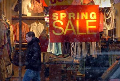 
Snow swirls around shoppers and spring sales on Main Avenue in downtown Spokane on Friday. 
 (Jesse Tinsley / The Spokesman-Review)