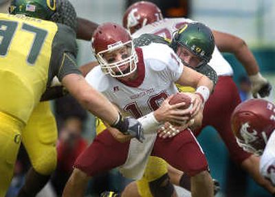 
Oregon Ducks defenders haul down Washington State Cougars quarterback Alex Brink for a safety on Saturday.
 (Christopher Anderson / The Spokesman-Review)