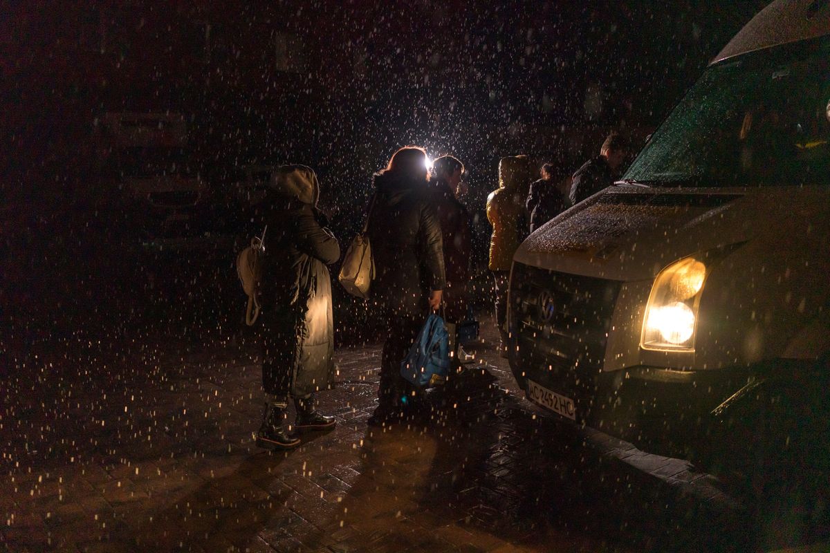 A group of 16 children, taken from Ukraine to Russian territory and brought back to Kyiv by the group Save Ukraine, board a bus to their overnight accommodations with their families in Kyiv, Ukraine on Feb. 2, 2023. Private donors have given the group some $7 million.    (Brendan Hoffman/The New York Times)