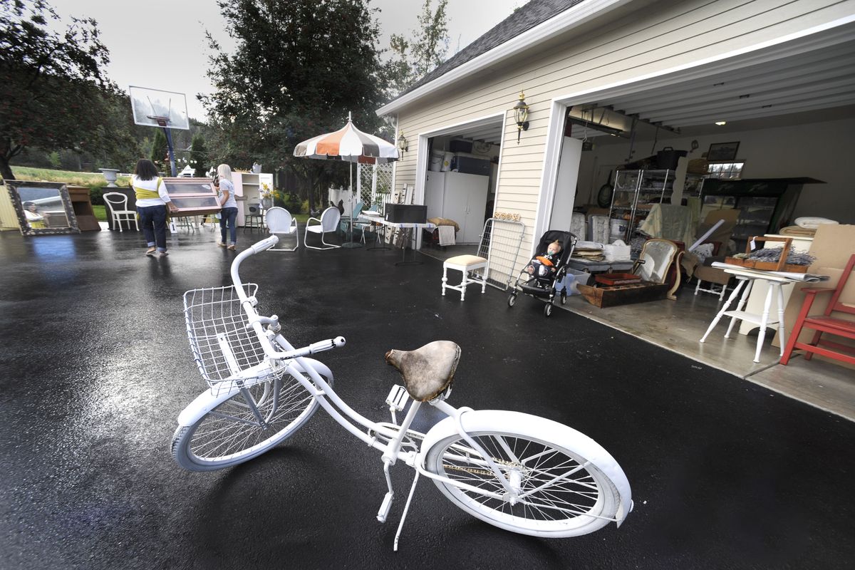 Gladys and Celia Hanning prepare for their Mad Hatter Vintage Flea Market by moving items out of the garage. (CHRISTOPHER ANDERSON / The Spokesman-Review)